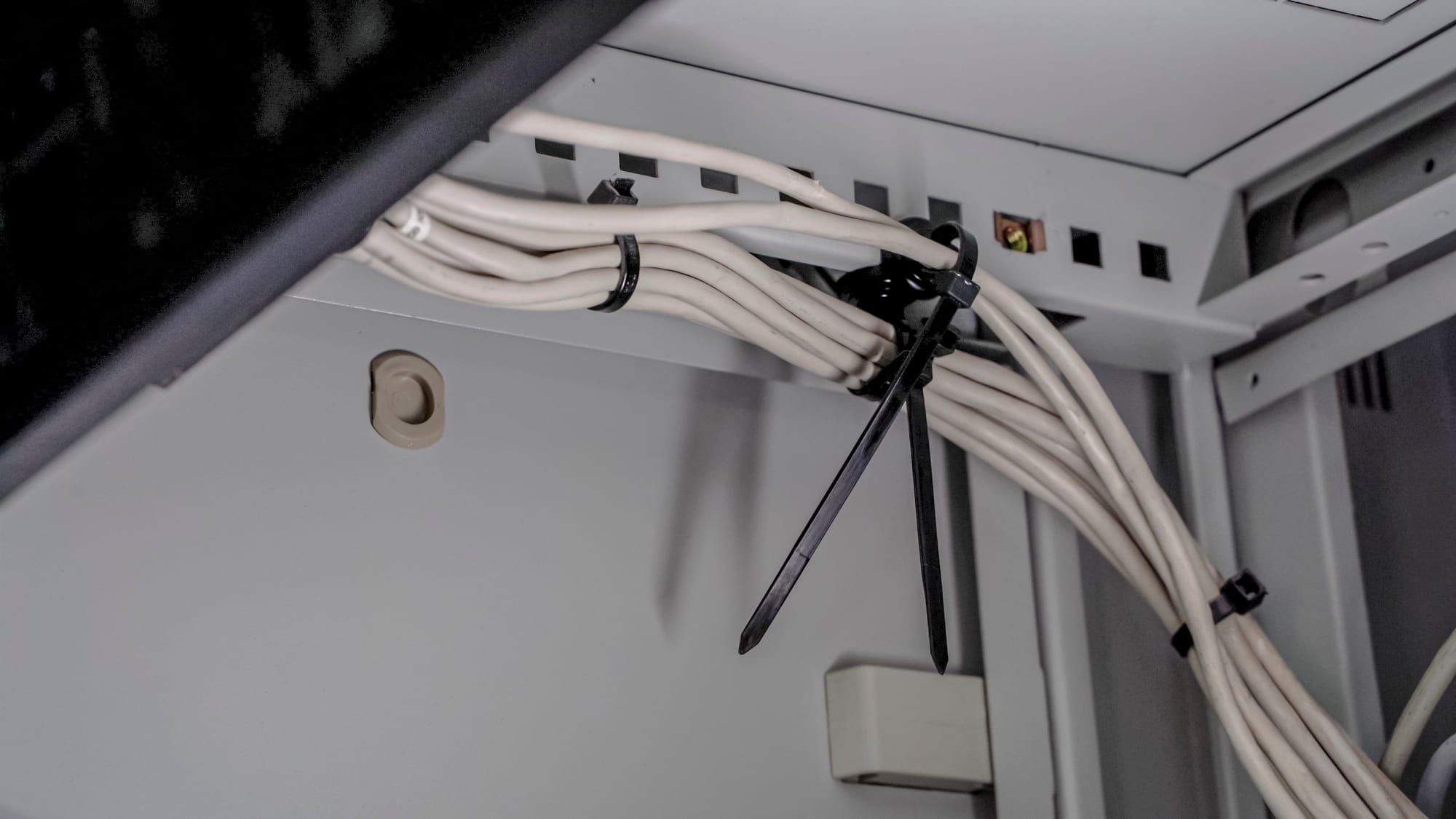 Network cables bundled to magnetic mounts inside a server rack